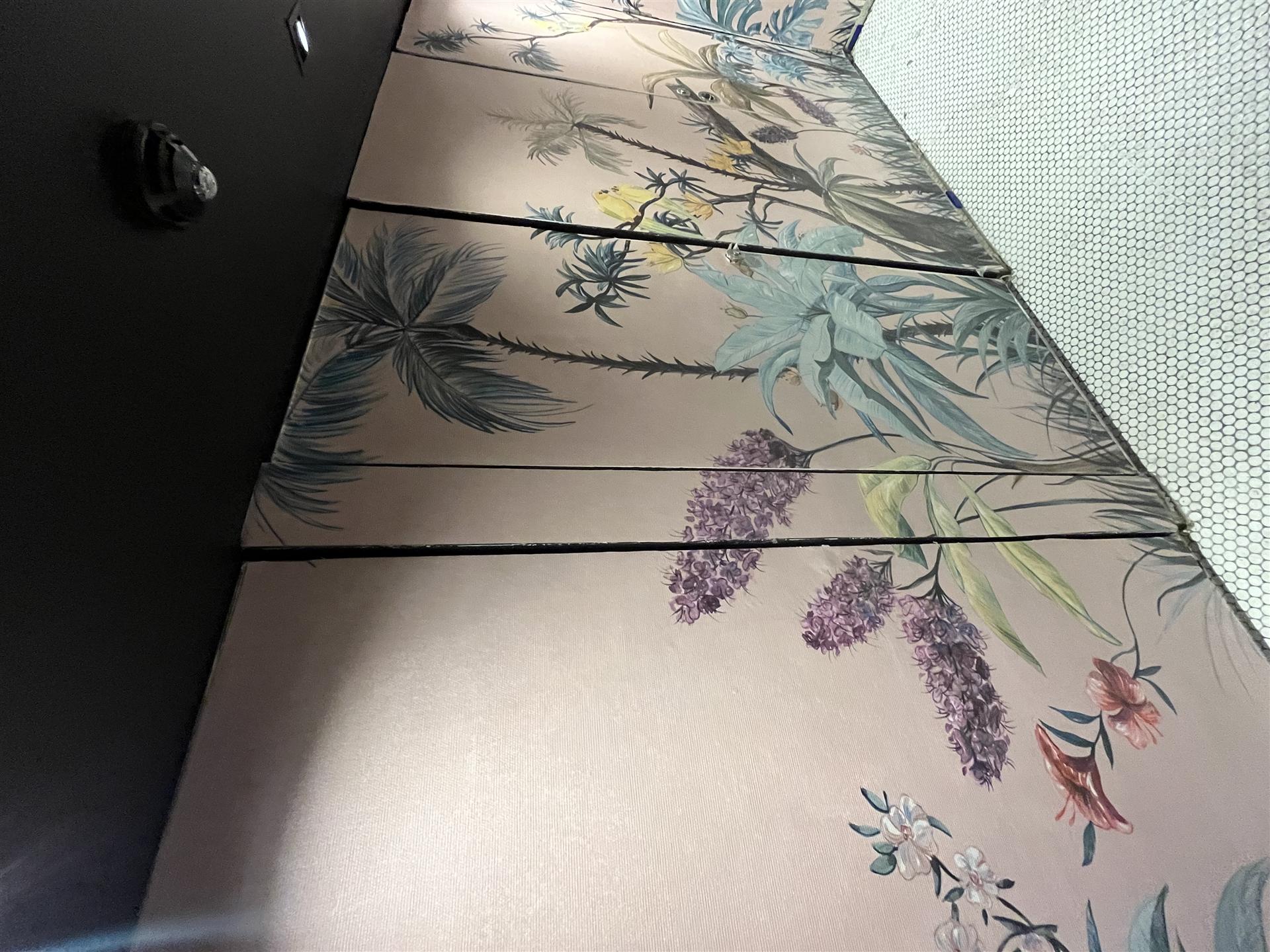 Close-up of botanical wallpaper installation detail, London